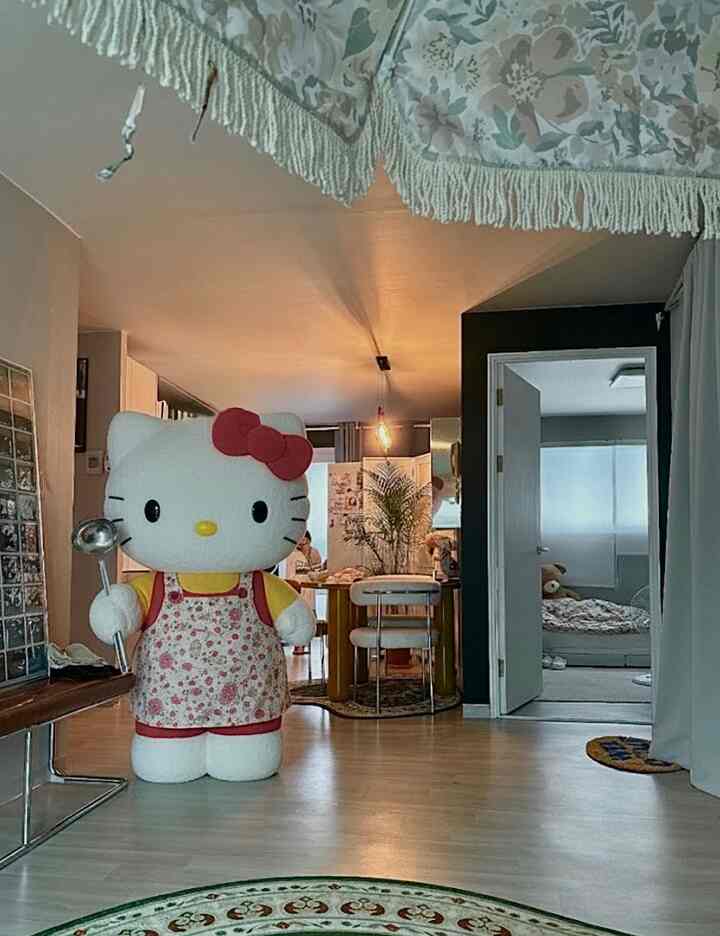 白を基調としたリビングとダイニング、巨大なハローキティのぬいぐるみが配置された温かみのある印象的な空間