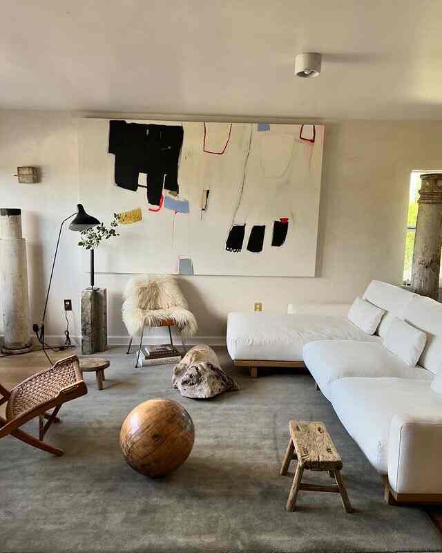 White and wood-tone bohemian living room featuring natural materials and cozy furniture creating a relaxed ambiance