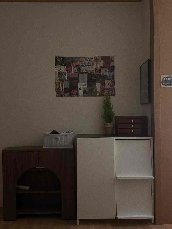 ブラウンの床とホワイトのキャビネット、ペットハウスがある居心地の良いリビングルームの風景