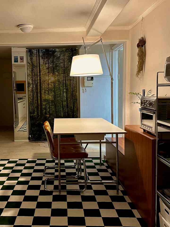 Beige-toned walls with white dining table and brown chairs in a contemporary connected living and kitchen space
