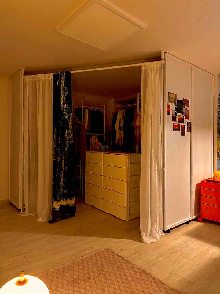 White and wood tone wardrobe and storage space in a cozy interior room