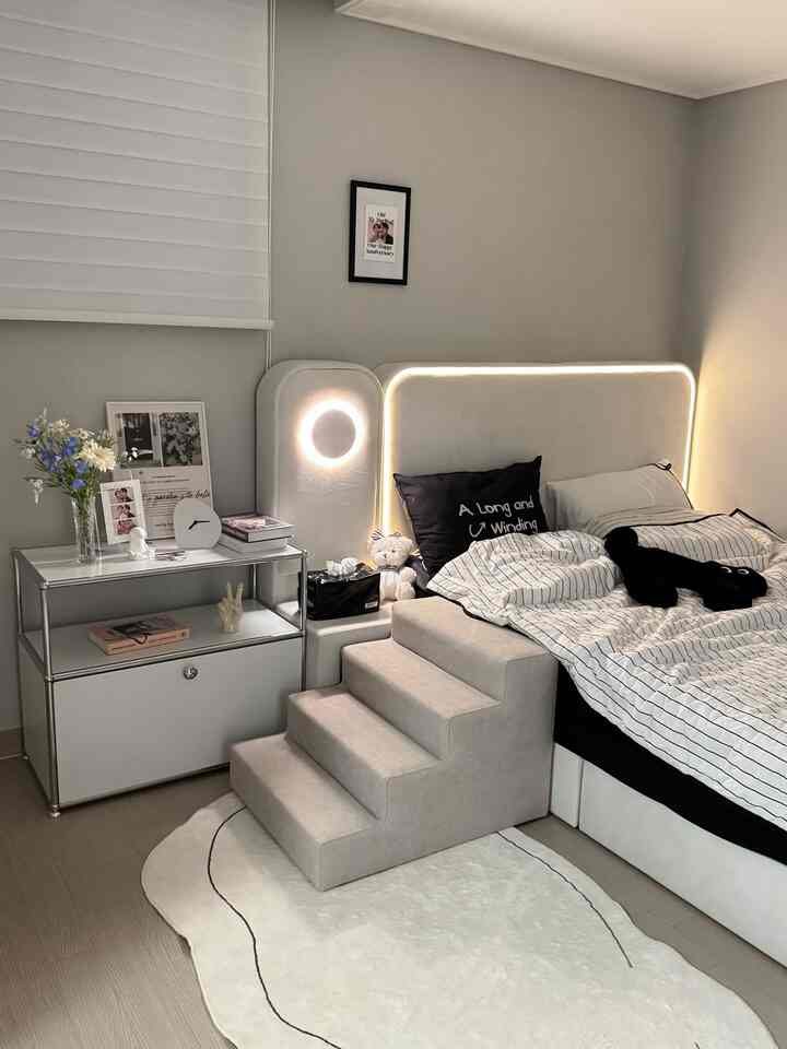 Natural color bedroom featuring beige bed frame and pet steps with a modern, cozy atmosphere