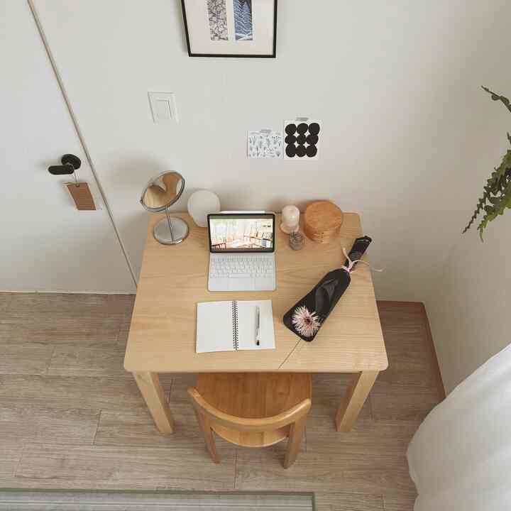 Natural wood tone and white compact home office space featuring a neat desk and chair setup