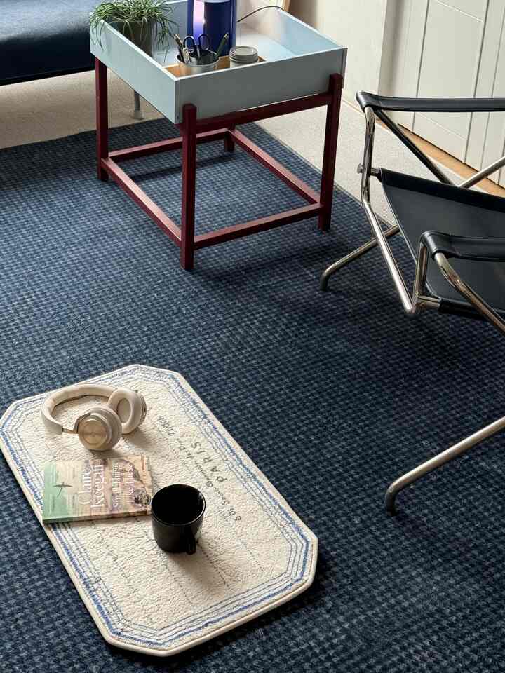 Navy-toned living room featuring a cafe-style side table and armchair with a cozy atmosphere