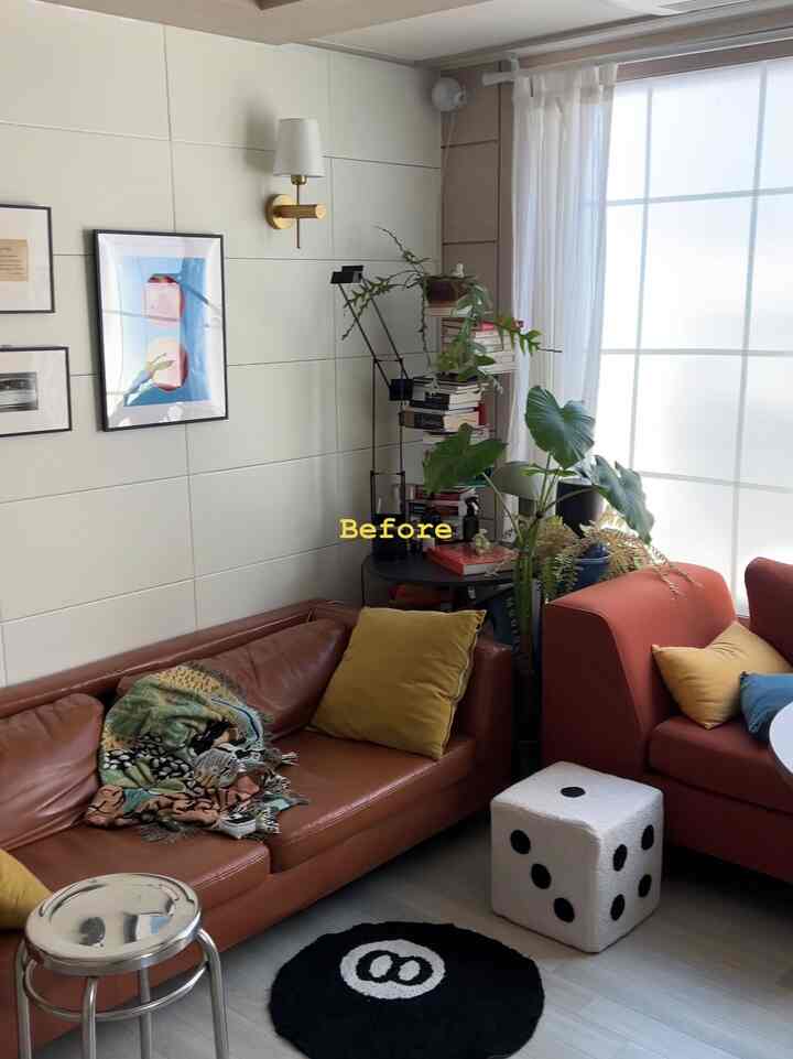 Modern living room in warm brown tones featuring two sofas, stools, and plants creating a cozy atmosphere