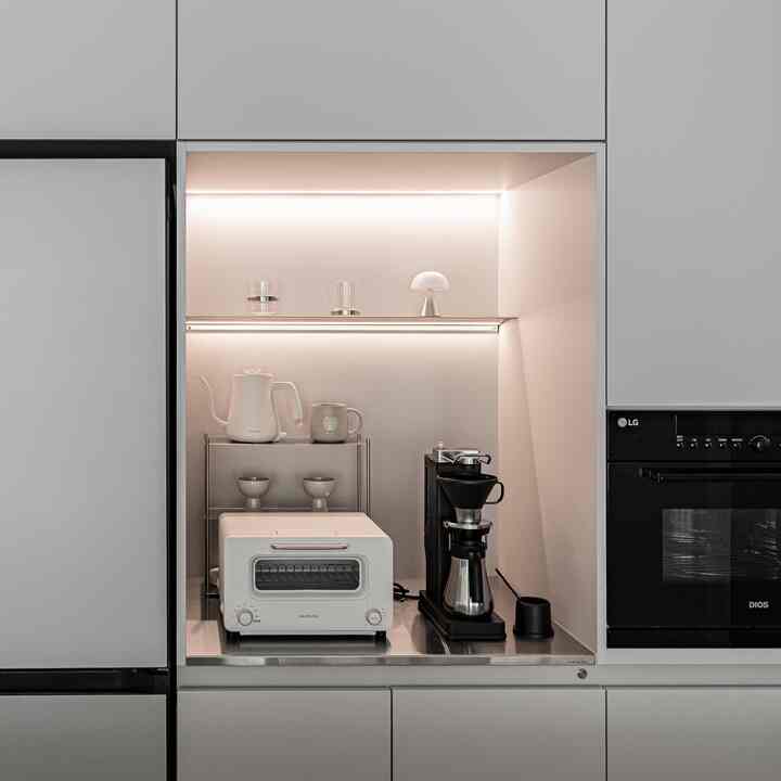 キッチンを1つ空にしたところ、ステンレス製のホームバーになりました☕

ちょっとした収納場にポイントを与えたいと思ってホームバーを作りました。
家電場を全部埋める代わりに、一箇所をオープンして
ステンレス天板とステンレス棚を入れたホームバーで作っています。
キッチンがすっきり見えないようにステンレス天板をポイントに入れて、よく使うコーヒーマシンとトースター・ポートを一箇所に集めました☕
上部と棚の下に照明を入れて
火をつけるとホームバーの部分だけがほのかに強調されるようにしました:)

キッチン一室ができたら収納場vsホームバー、どんなものを選びますか？

#キッチンインテリア＃ミニマルインテリア＃34フラットインテリア＃アパートインテリア＃アパートツリーモデリング＃オープンスペース 
＃バルミューダトースター＃バルミューダーザポット＃バルミューダコーヒーポート＃バルミューダコーヒーマシン＃バルミューダ 
