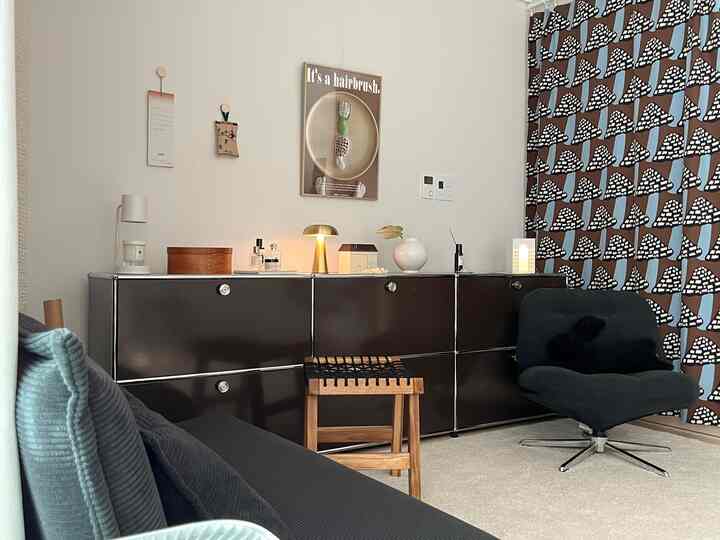 白い壁と黒い家具が調和する北欧風のシンプルで洗練されたリビング