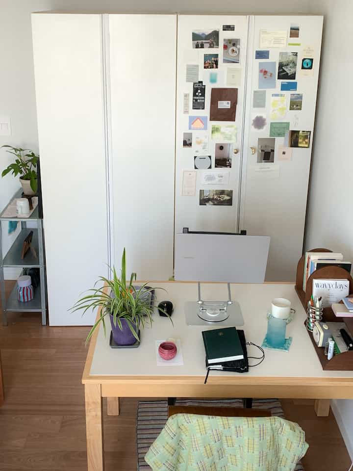 白と木目調が調和する一人暮らしのコンパクトなホームオフィス空間、机と4扉のクローゼットが配置され、すっきりと実用的な雰囲気