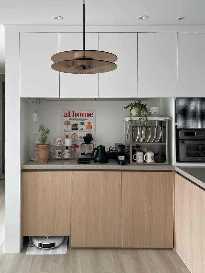 ホワイトとブラウンのトーンのキッチンスペース、ドリップコーヒーセットとステンレス製の棚が整然と配置されたナチュラルな雰囲気のインテリア