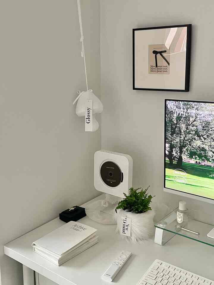 ホワイトトーンのホームオフィス、シンプルで洗練されたデスクとモニタースタンド、植物が配置された雰囲気のあるインテリア