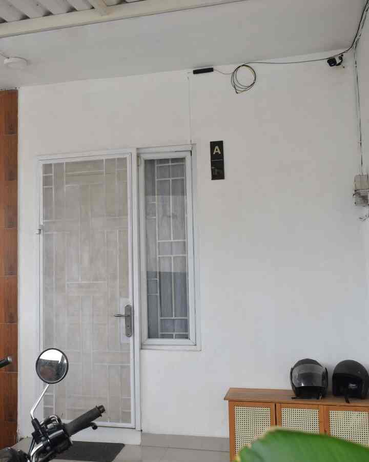 White and brown toned entrance featuring wooden shoe cabinet in a clean space