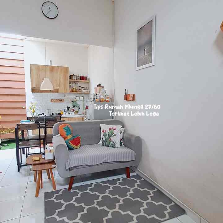 Gray-toned living room and kitchen in a compact modern space, featuring a gray sofa and wood-tone furniture creating a cozy atmosphere