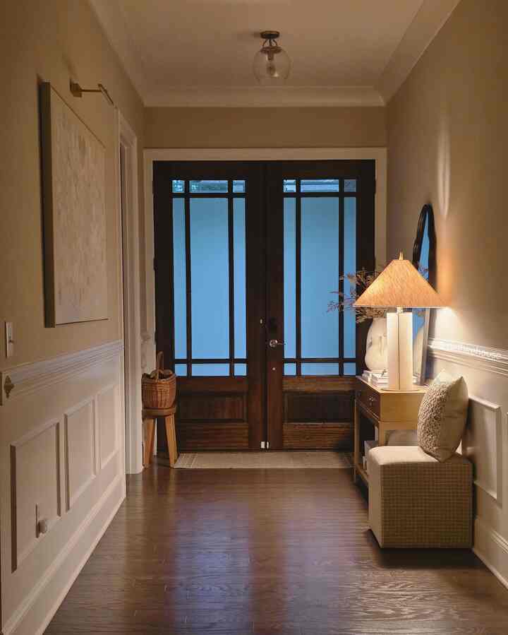 Beige-toned entrance with wood tone flooring and warm lighting creating a cozy atmosphere