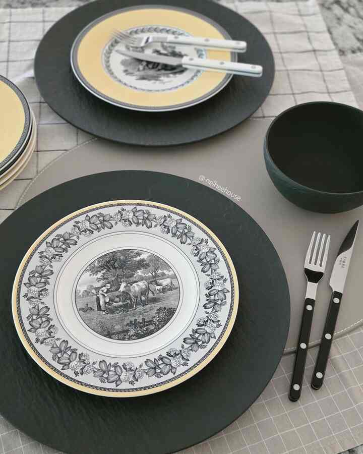 Black and yellow toned table setting featuring plates and cutlery in a simple styled home cafe atmosphere