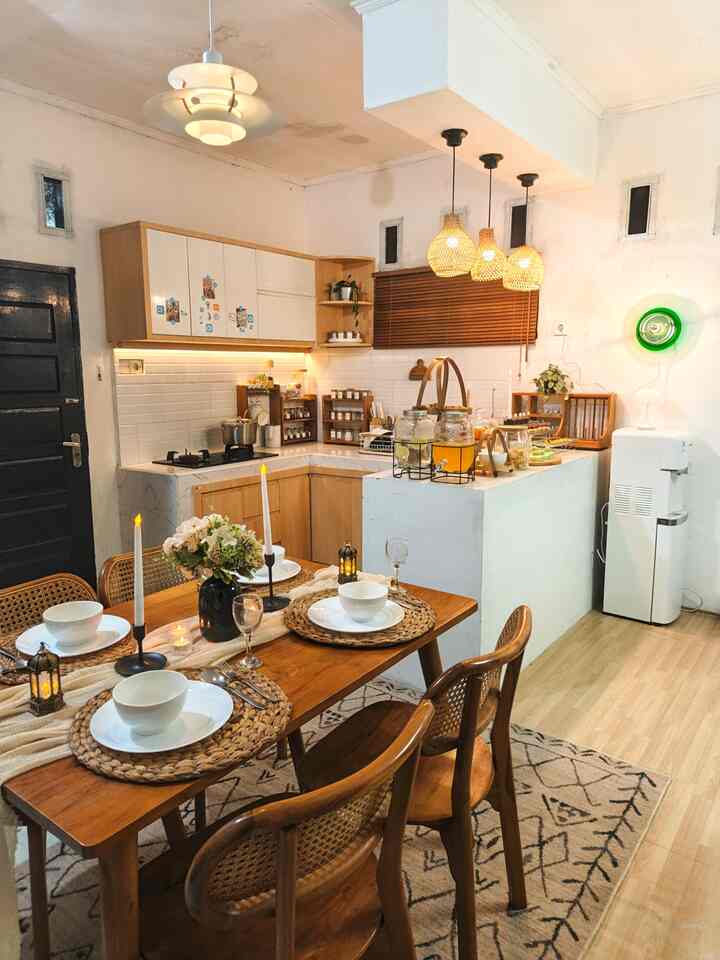 Natural tone kitchen and dining room with wooden table and chairs, creating a cozy and clean space