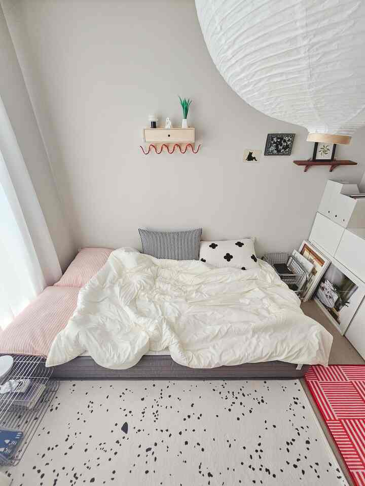 Beige-toned walls and white bedding dominate the simple, natural modern bedroom