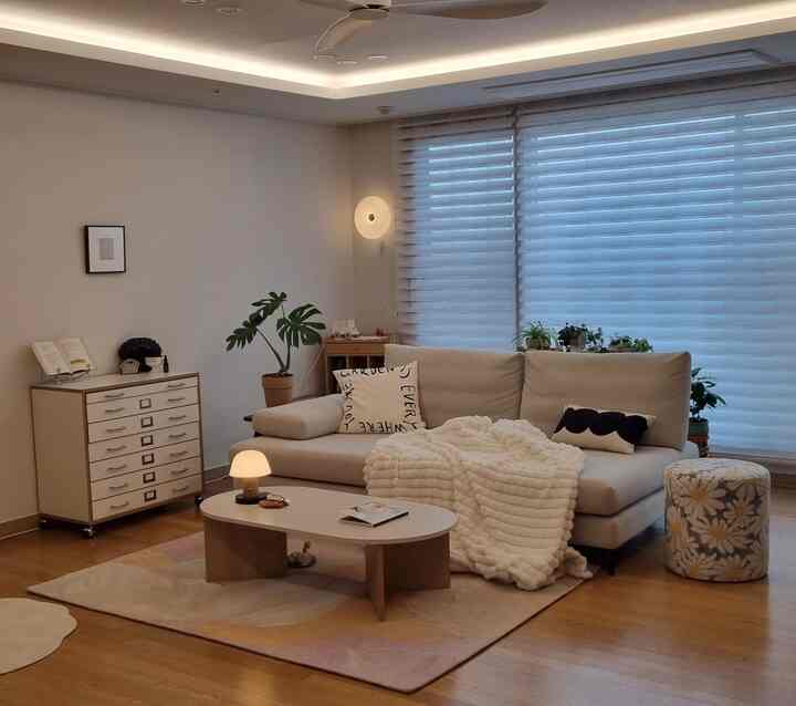 Beige and light brown toned living room featuring face-to-face sofa and storage chest in a natural modern style space