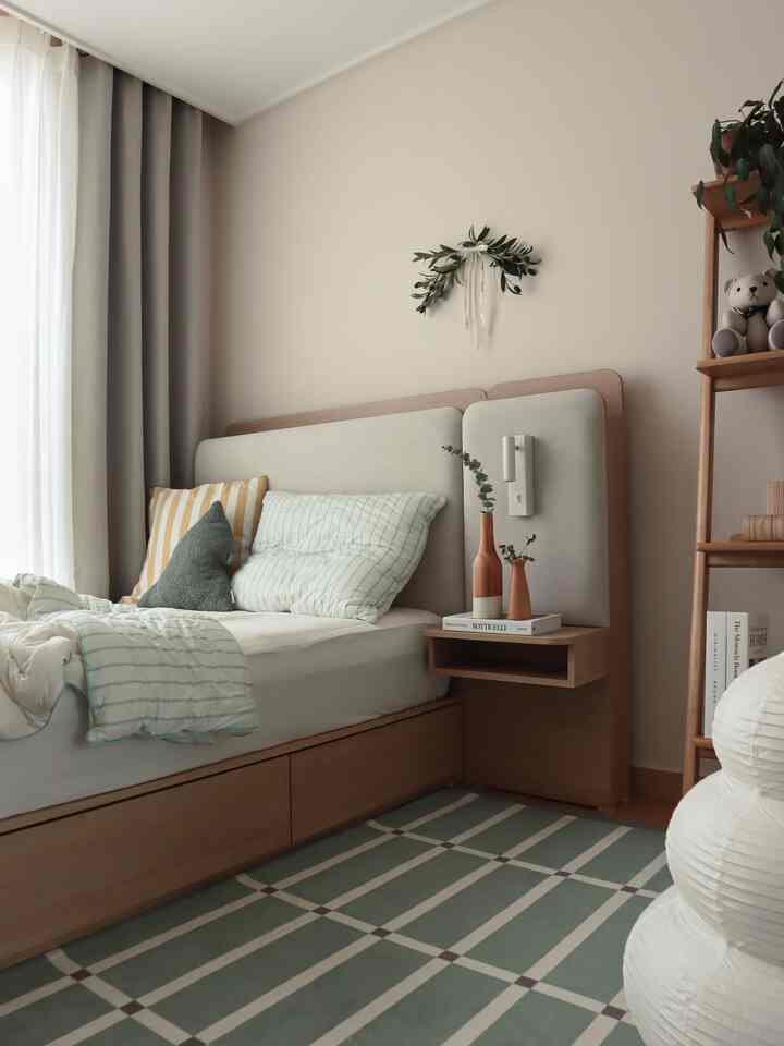Beige natural-toned kids' room featuring wooden bed and shelf, complemented by green checkered rug creating a warm atmosphere