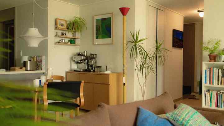 Natural wood tone dining room featuring a Lokki pendant light and dining table creating a cozy, natural modern atmosphere