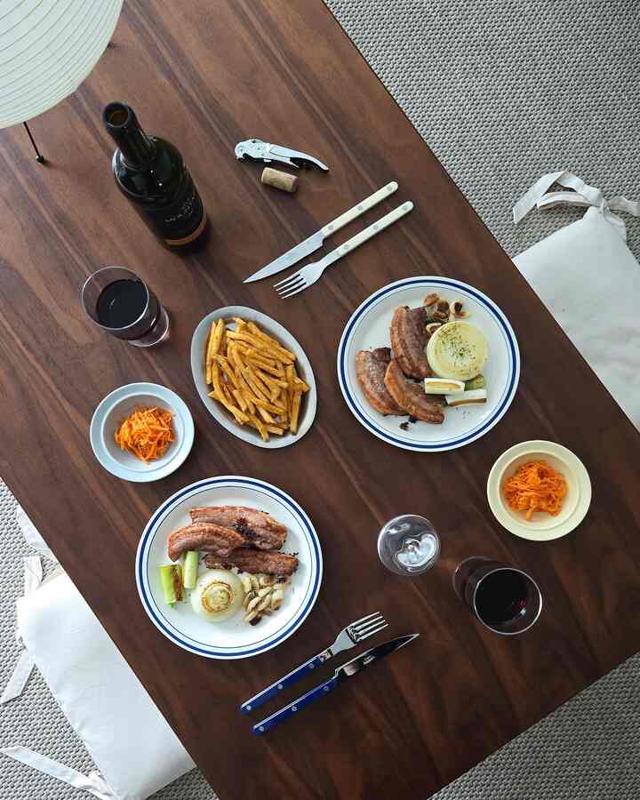 ウッドトーンのダイニングルーム、ワインと料理が置かれたカフェ風の落ち着いた空間