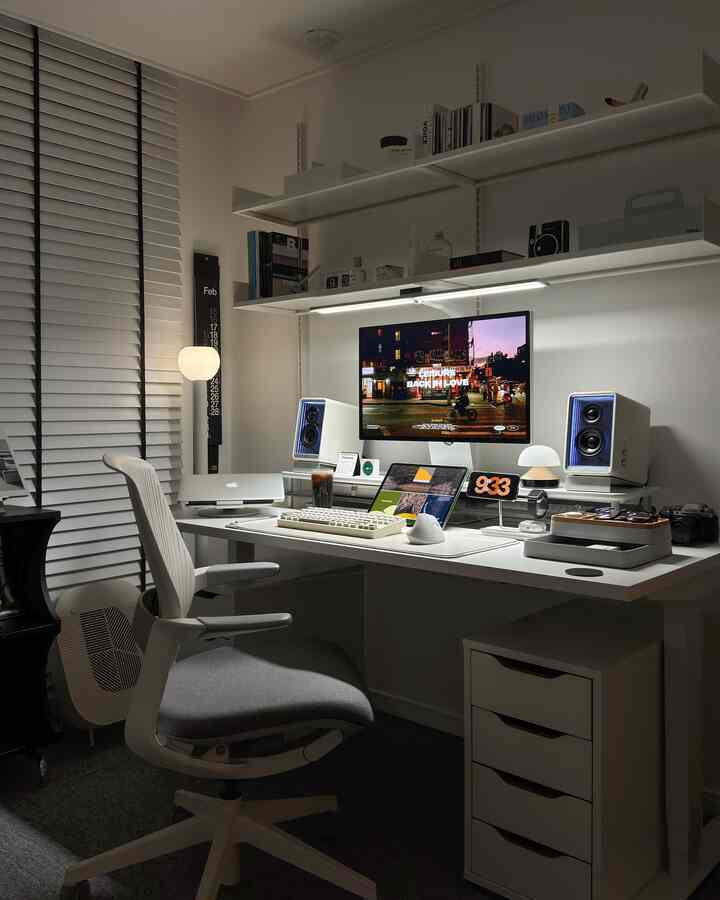 ホワイトとグレーのトーンの書斎ホームオフィス、コンピューターデスクと収納棚、モニターとスピーカーが配された雰囲気のある空間