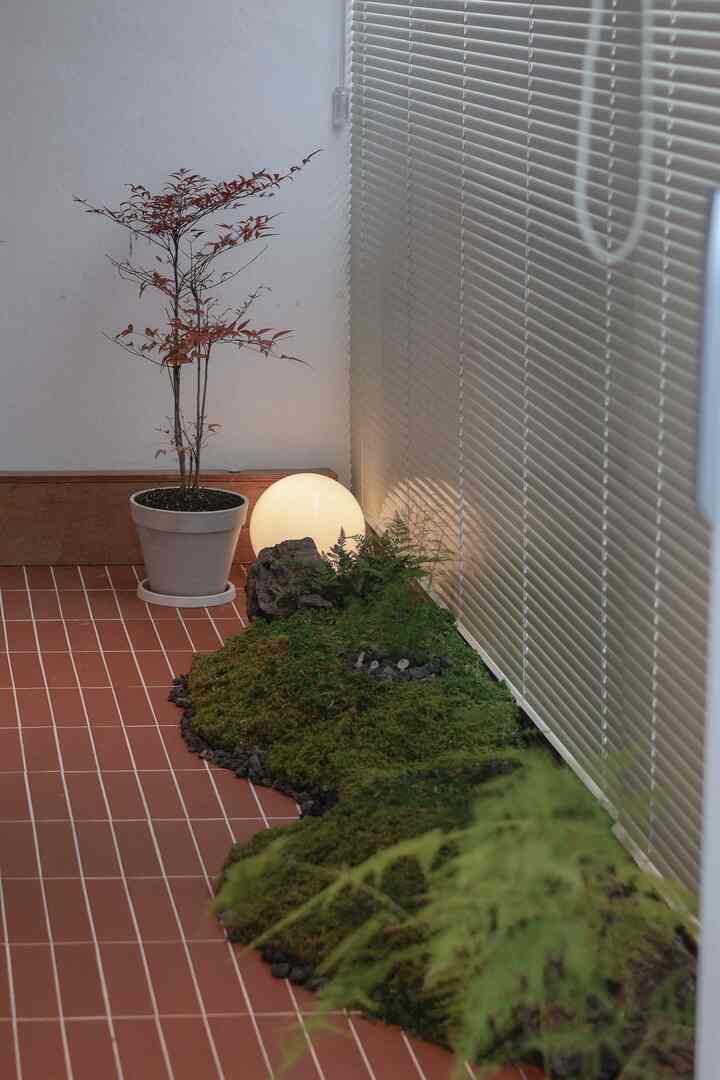 Terracotta floor veranda with blinds, featuring artificial moss garden and Nandina tree creating a natural ambiance