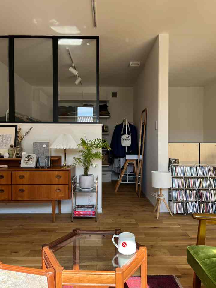 Wood tone and white themed walk-in closet with vintage mid-century modern furniture in a tidy space