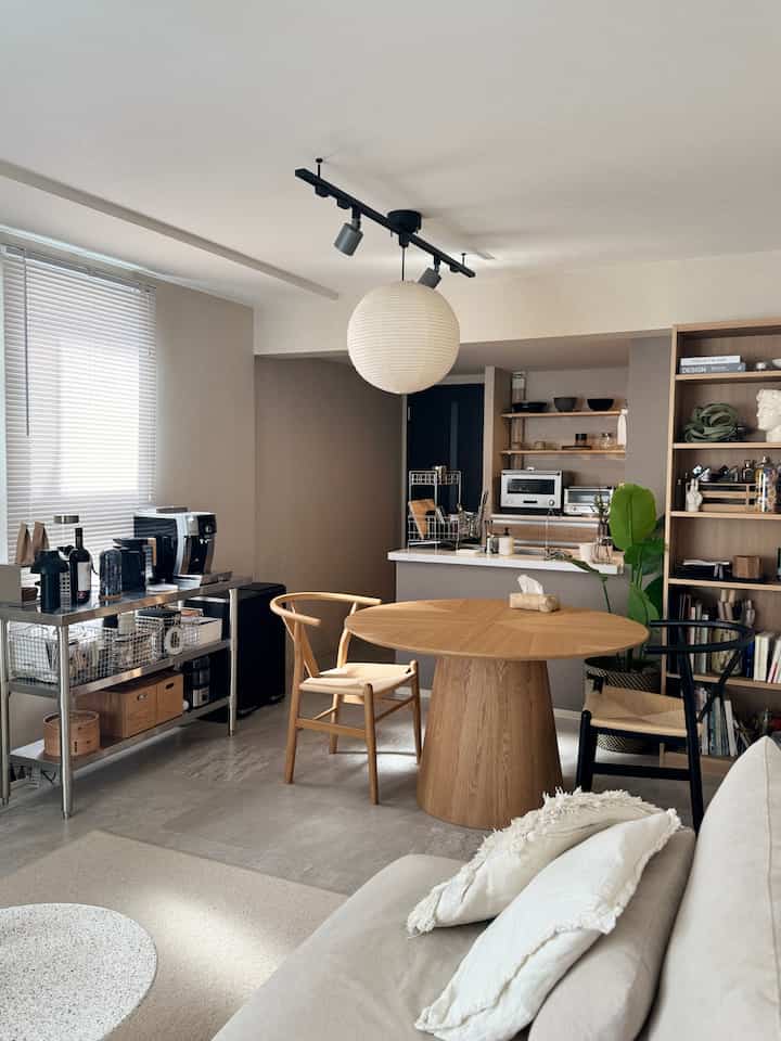 アイボリー色の壁と木目調のダイニングテーブル・チェアが配置された北欧風の2LDKリビング、落ち着いた雰囲気のインテリア