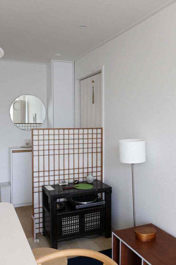 Natural color and white-toned living room featuring a shelf and floor lamp with calm atmosphere