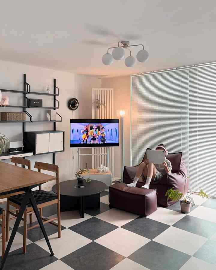 Modern living room in white and brown tones featuring a leather bean bag sofa and round coffee table