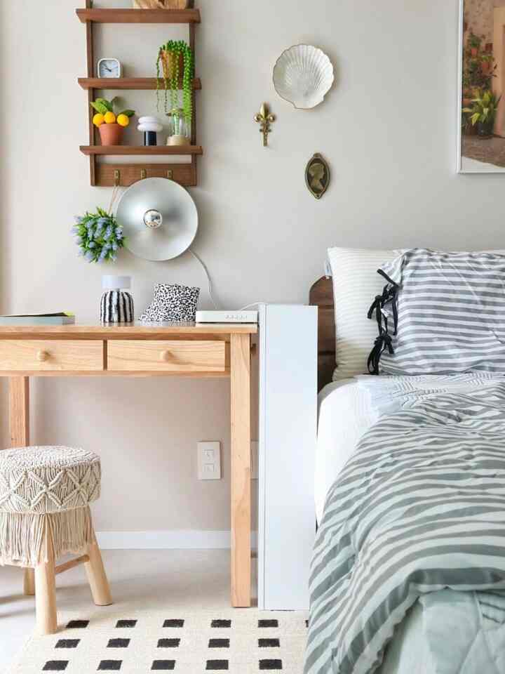 Natural wood tone and white bedroom featuring a desk and storage with a clean and simple arrangement