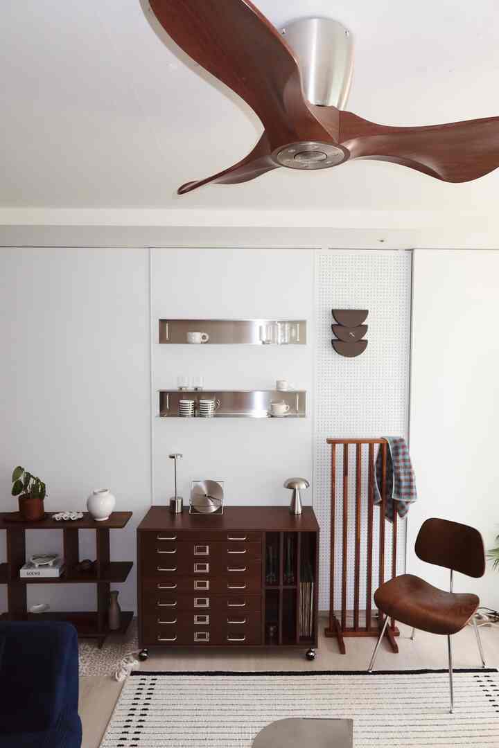 白い背景のリビング、茶色い木製家具とシーリングファンが調和したモダンでナチュラルなインテリア