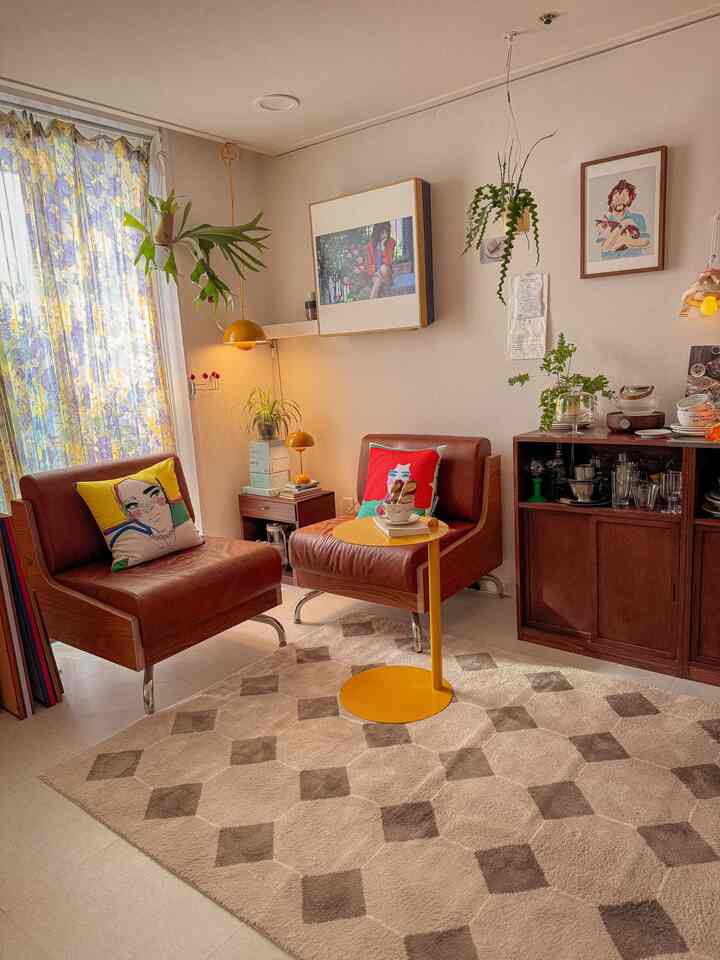 Warm brown and yellow tone Art Deco living room featuring two leather armchairs and a yellow side table in a cozy setting