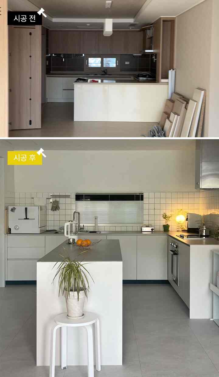 白とグレーのトーンのキッチンとオープンダイニング、中央にキッチンアイランドが配置されたシンプルでモダンな空間