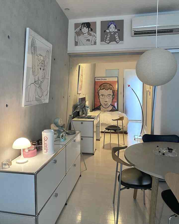 ライトグレーとホワイトの色調のダイニング、丸いダイニングテーブルとペンダントライトが配置されたミニマルな印象のインテリア