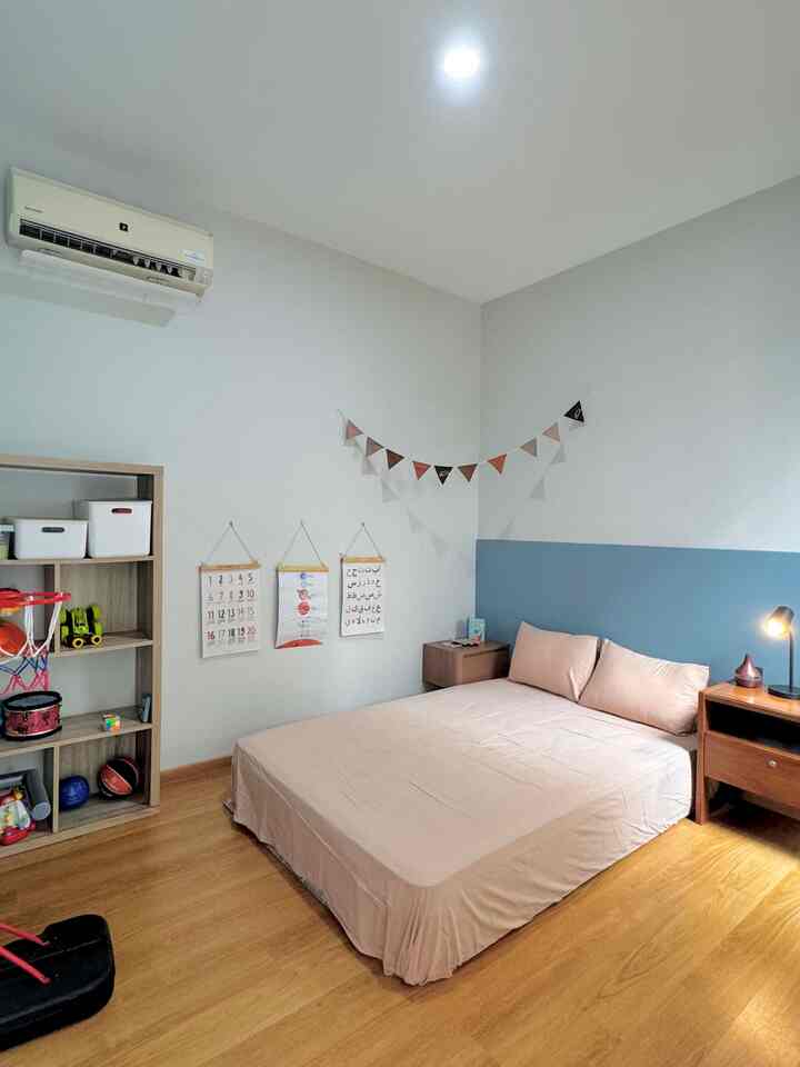 Natural wood tone and white-blue walls in a kids' room featuring a beige bed at center and bookshelf with toys, creating a cozy atmosphere