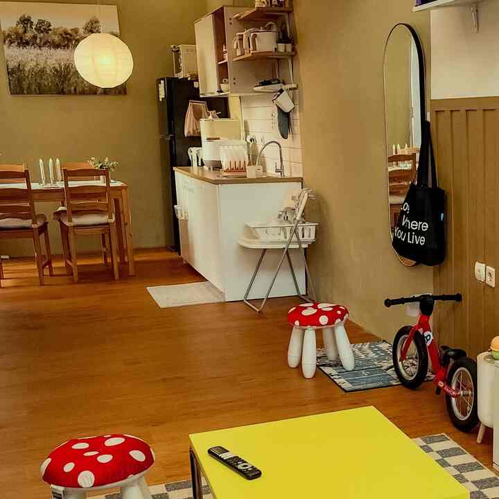 Natural color and wood tone kitchen and dining room featuring baby and kids items creating a warm family space