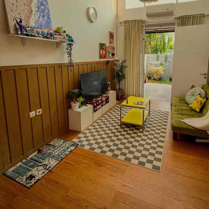 Natural color and wood tone living room featuring green sofa and yellow coffee table in cozy setting