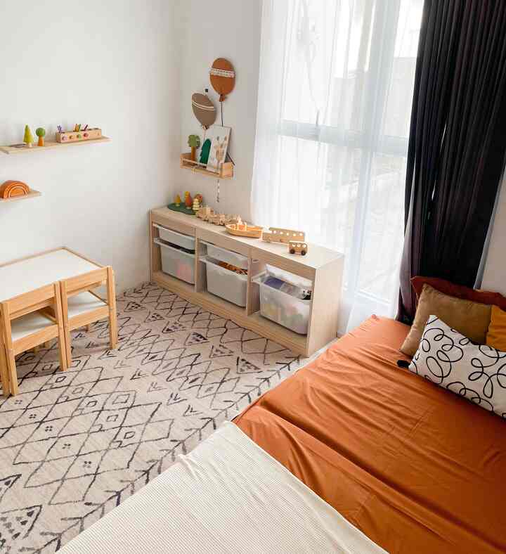 Bright white and brown toned kids' room featuring children's furniture and toy storage, creating a warm and inviting atmosphere