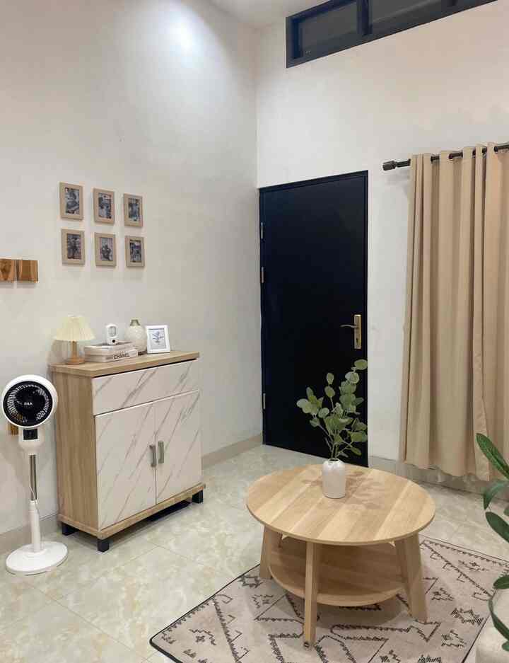 Natural color simple living room featuring round coffee table, cabinet, and beige curtains with a clean atmosphere