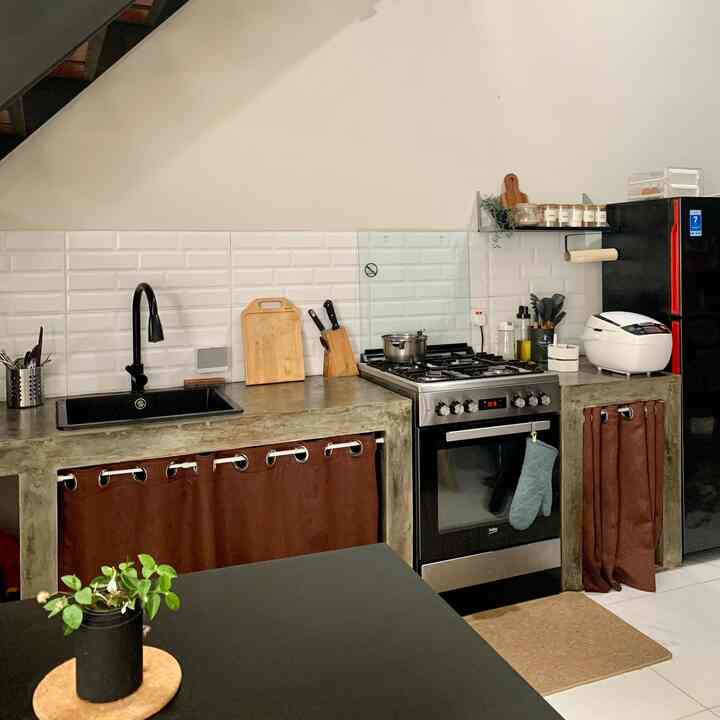 Focal point di dapur kami adalah semen expose dan freestanding stove nya.
Kami menambahkan ambalan kecil dibagian sisi kanan dapur, sebagai pemanis dan juga sebagai tempat menyimpan bumbu-bumbu dapur yang paling sering terpakai. Kami juga menambahkan nuansa kayu-kayuan disini agar suasana terasa hidup.
Cara kami agar dapur terlihat rapi adalah dengan segera memulangkan barang-barang ke rumahnya, untuk alat-alat masak semuanya kami simpan di sebalik gorden kolong. Jadi dapur kelihatan lebih rapi dan bersih. 
#kitchenstyling #kitchendecorideas #kitchenmakeover #kitchenindustrial #rumahdeveloper