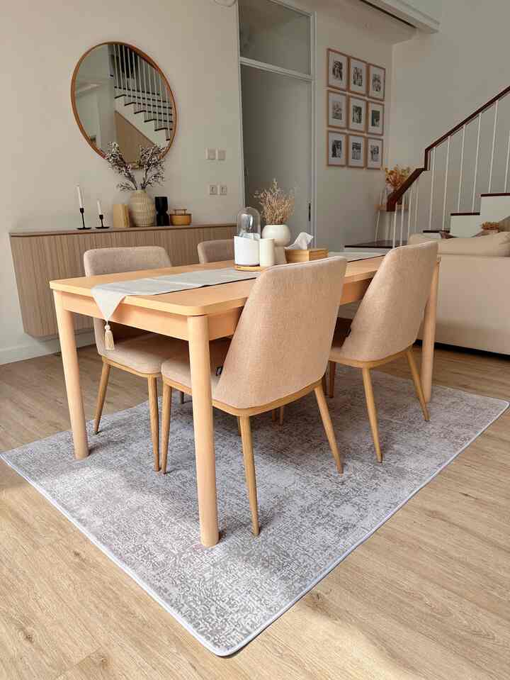 Natural tone wood-toned dining room featuring a wooden dining table with beige chairs creating a cozy atmosphere.