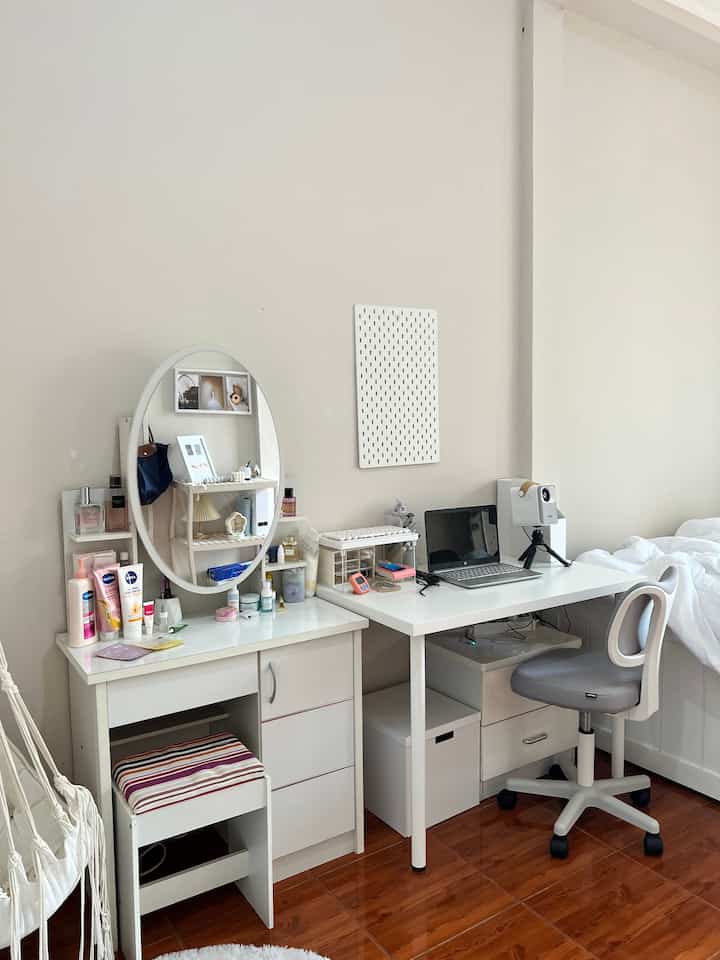 White-toned kids' room featuring a vanity and desk neatly arranged, creating a clean and organized space