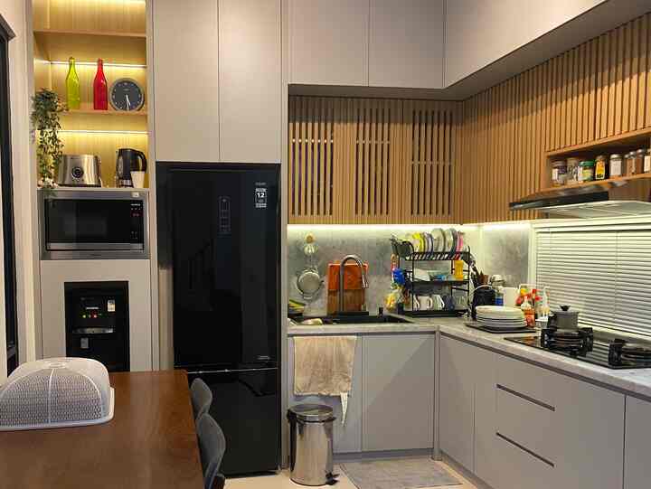 Wood tone and white kitchen featuring a dining table and smart storage ideas in a compact space