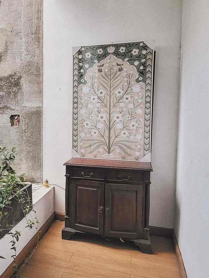 Natural beige walls and brown wood-tone cabinet with floor and plant create vintage-style corner space