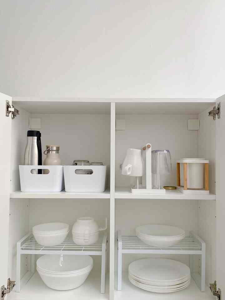 White-toned cabinet with neatly organized kitchenware storage