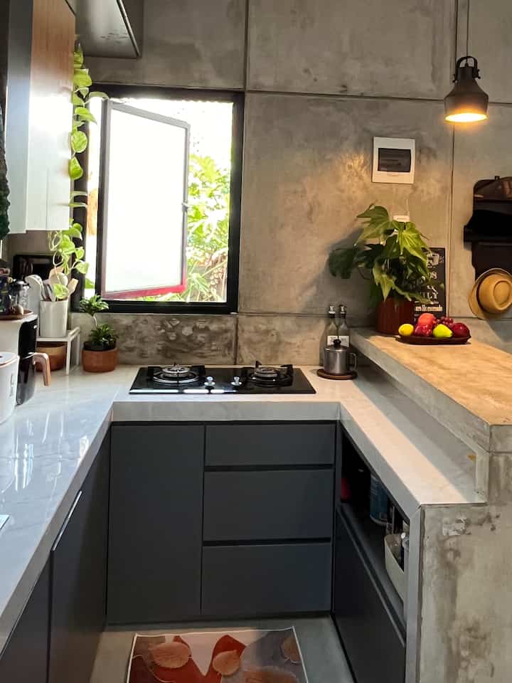 Dapur kami mengusung konsep kitchen industrial modern.
Pembuatan meja bar cor coran serta tembok semen unfinished dipadu dengan keramik warna putih serta cabinet warna abu kombinasi wood diharapkan dapat memberikan kesan unik dan menarik.

Dapur kami yang menjadi bagian dari open & multifunction floor di lantai 1, terletak di bagian depan, dengan jendela ke arah teras.

Untuk mensiasati ruangan yang terbatas dengan ukuran, 2.35m x 1.5m, dapur dibentuk U, dengan penempatan sink dan kompor diatur sesuai urutan alur kerja di dapur. Cuci, preparation, masak lalu penyajian.

Pembuatan #mejabar sengaja tidak sejajar dengan top table dapur. Jadi ada space tambahan buat multi tasking preparation sarapan sekaligus nyiapin bekal makan siang.

Semoga bisa menjadi inspirasi ya.


#KitchenStyling #dapurmungil #dapurindustrial 
#ideDekorDapur
#Makeoverdapur