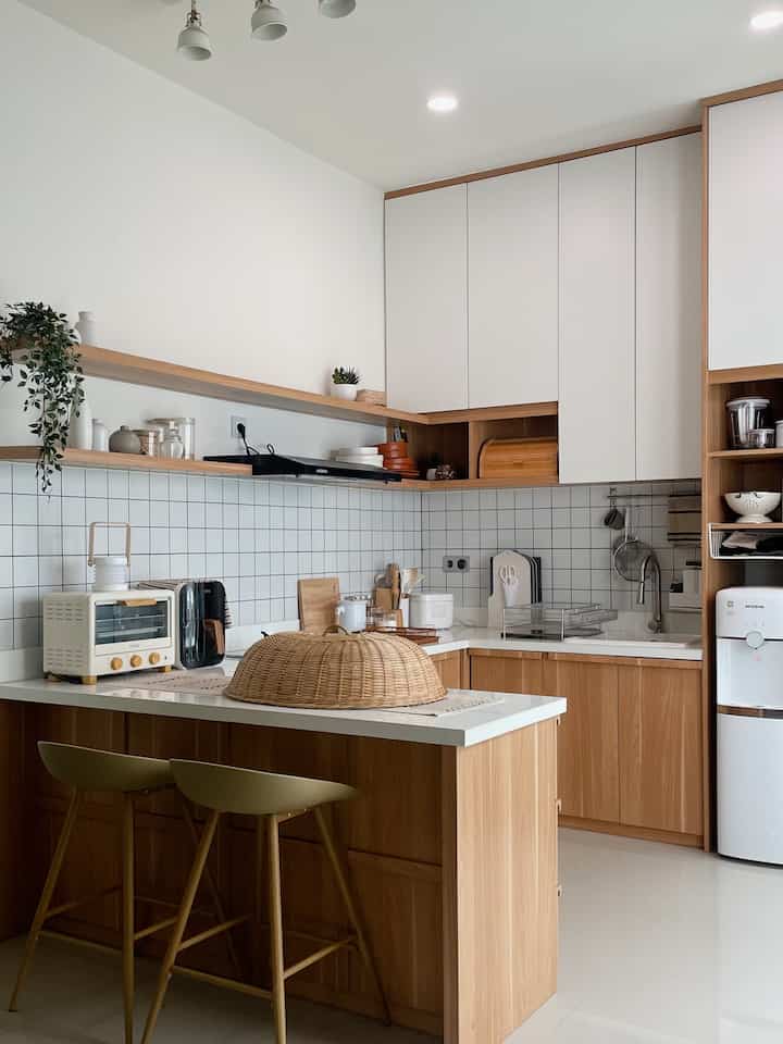 Bright white and wood tone Japandi kitchen with clean design and efficient storage solutions