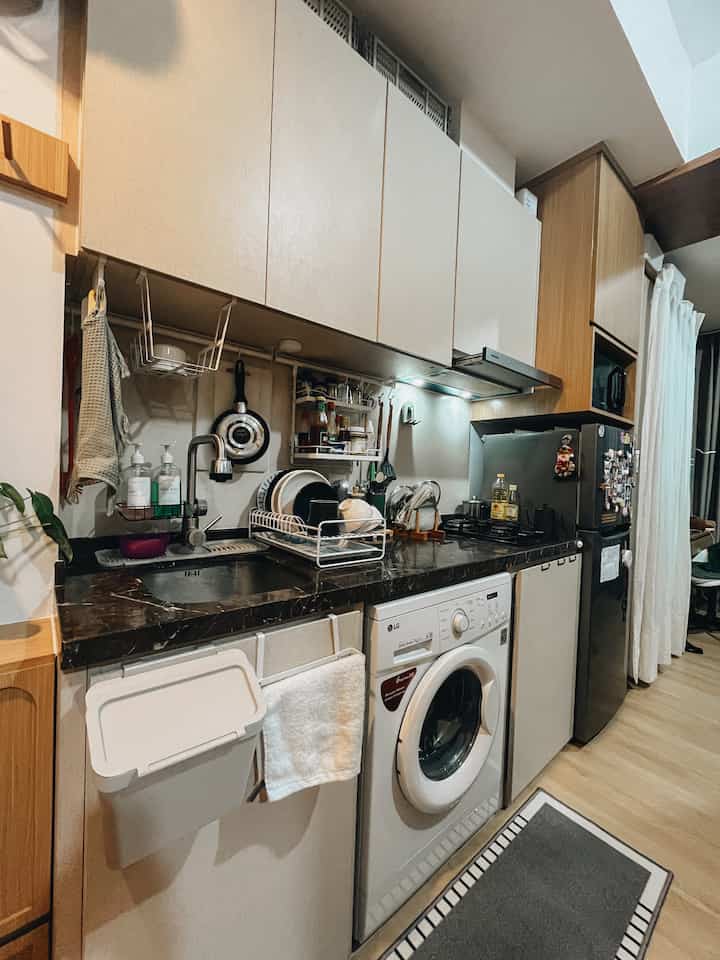 Ini dia dapur kecilku. 
Karena tinggal di apartemen studio, dapurku cukup compact. Oleh karena itu aku harus bisa menata dapurku dengan baik sehingga semua barang bisa muat.
Aku menggunakan rak piring yang cukup ramping agar tidak mengambil banyak space di countertop.
Selain itu juga aku menggunakan rak bumbu yang menggantung sehingga bisa memanfaatkan area kosong pada backsplash. 
Dan tidak lupa menambahkan tanaman hijau walaupun kecil untuk menambah warna di dapurku.
Well, this place is not much, but it’s enough. ❤️

#KitchenStyling
#IdeDekorDapur
#MakeoverDapur
#tinykitchen
#livingbigintinyhouse