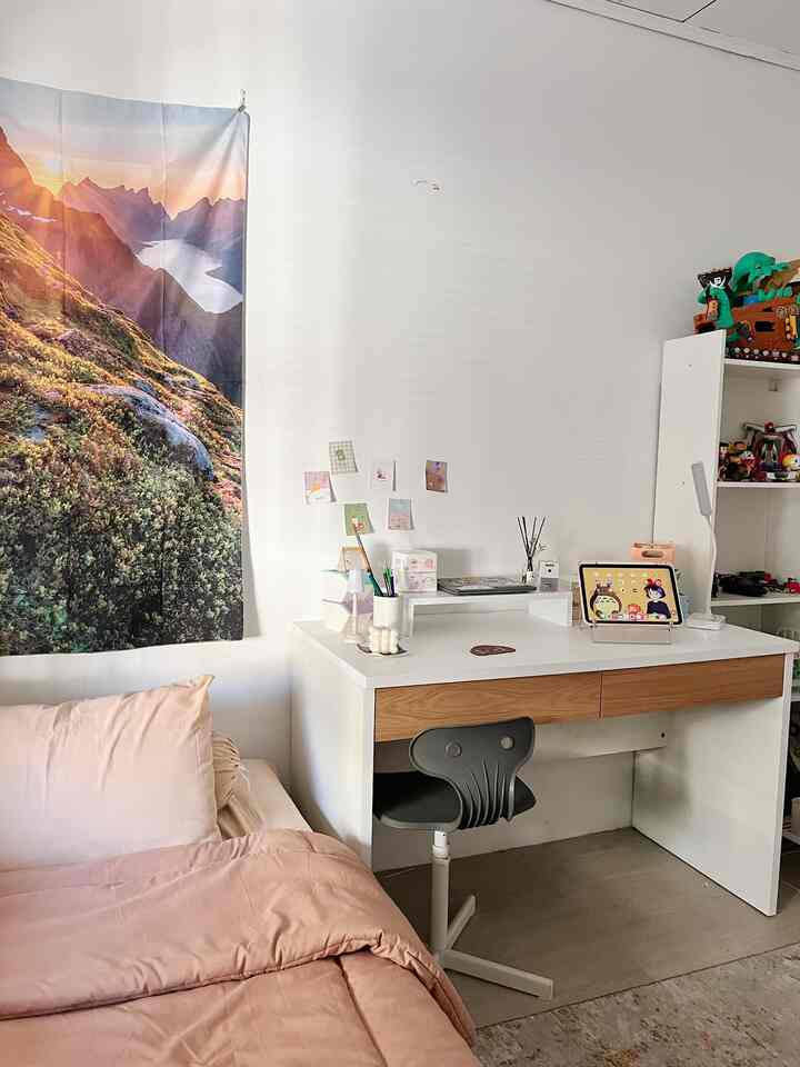 White and brown toned bedroom featuring a desk and simple stool in a minimalistic space
